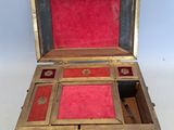 a small wooden box with a red lining inside of it