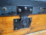 a close up of a wooden trunk with a lock on it