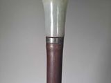 a white and brown cane that is on a table