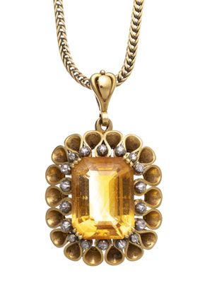 une image représentant un collier orné d'une pierre jaune entourée de diamants