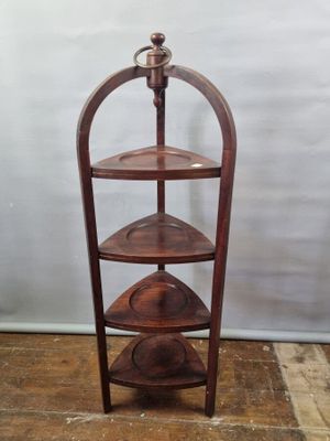 an image of a three tiered wooden display stand on a hard wood floor