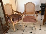 two chairs that are sitting next to each other in a room