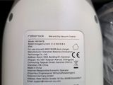 a bottle of liquid sitting on a table next to a plastic bag