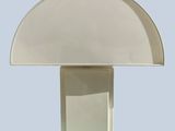 a white table lamp with a white shade on top of it