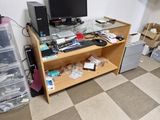 a desk with a computer monitor, keyboard, and other items on it
