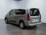 the silver van is parked in the large room of the building