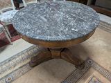 a table with a marble top in a living room