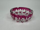 purple glass bowl with silver decoration on white surface