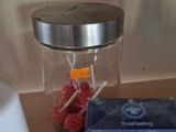 a box of gum and a container of toothpaste on a table