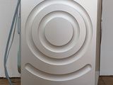 an image of a washing machine on wheels on a tiled floor
