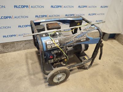 the generator is sitting on the floor in front of the wall