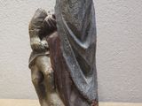 a statue of a woman holding a baby on a table