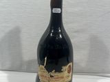 a bottle of wine sitting on top of a white table