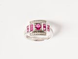 a close up of a ring with a pink stone and diamonds