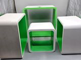 a small green and white table and two small white stools