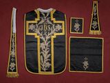 a black and gold vest with a cross on it