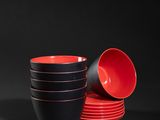 red and black bowls and cups on a black background