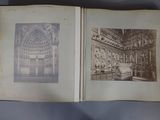 an old photo of a book opened to show a picture of a building