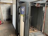 a metal door that is open in a building