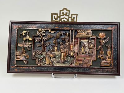 a picture of a wooden plaque with a picture of people