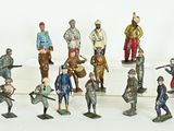 many figurines of soldiers standing on a white surface