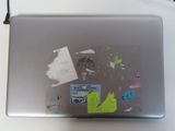 a laptop with a sticker on it sitting on a table