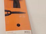 a pair of scissors in the package on the table