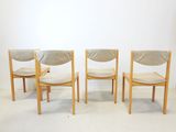 three wooden chairs with upholstered seats in a white room
