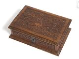 an old wooden box with a bird design on the lid