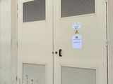 a white building with two doors and a sign on it