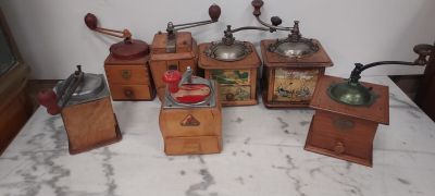 many different types of coffee grinders on a table