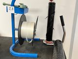 a picture of a table with a spool and a roll of tape on it