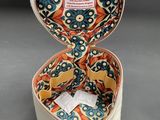 a small white box with a floral pattern inside