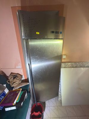 a silver refrigerator in the corner of a kitchen