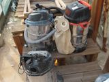 a pile of vacuums and other equipment on a wooden pallet