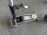 a baseball bat that is laying on the ground next to a bat stand