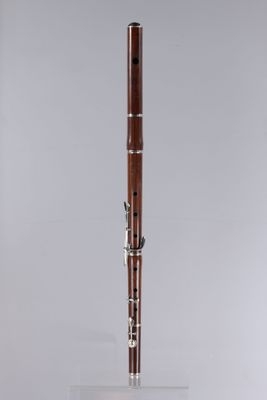 an old bassoon on a clear surface with a white background