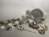 a lot of silver and silverware on the table