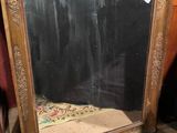 a mirror that is sitting on the floor next to a chair