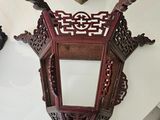 a picture of a mirror and a statue on a table