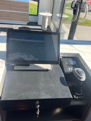 a laptop computer sitting on top of a black desk