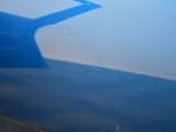 a shadow of an airplane on the side of the plane