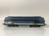 a blue and white train on a white surface