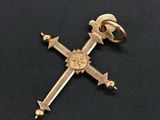 a close up of a cross on a black surface