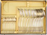 many forks and spoons in a box on the table