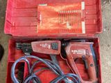 a person holding a corded drill in a red box
