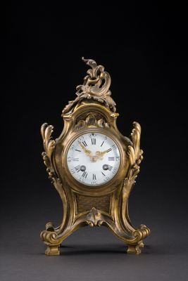 an image of a gold clock sitting on top of a table