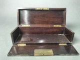 a small wooden box with two open compartments on it