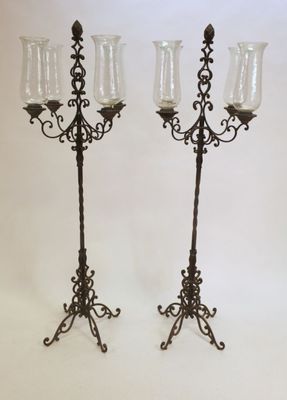 pair of antique wrought iron candelabs with glass vases