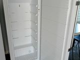 a white refrigerator with its door open in a room